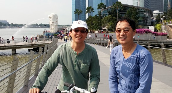 On a bridge with the Merlion behind