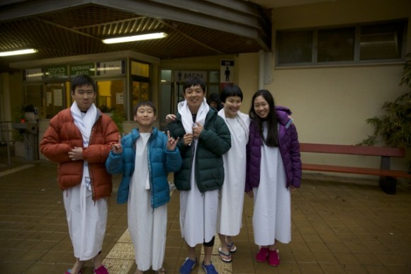 After baptism the parents quickly put on jackets on their kids except one kid