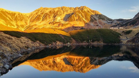 Beautiful reflection on still waters of the crater lake. The mountain has lost its "beefy" look.